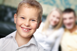boy smiling in front of parents